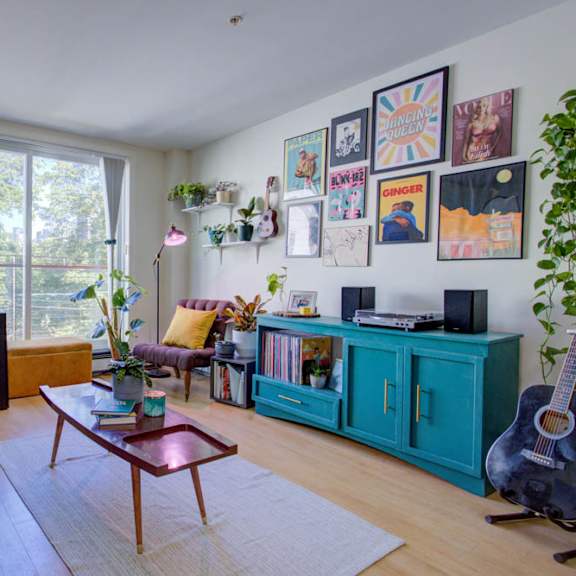 a living room with a green chair and a wooden coffee table.