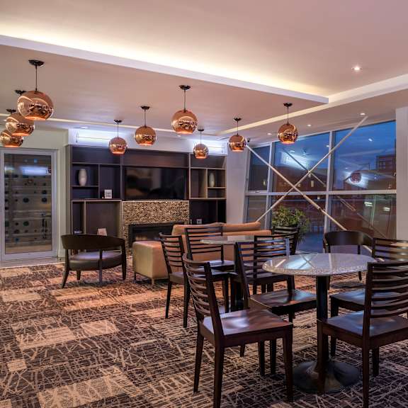a modern dining room with a large table and chairs.