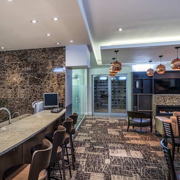 a modern kitchen with a marble backsplash and granite countertops.