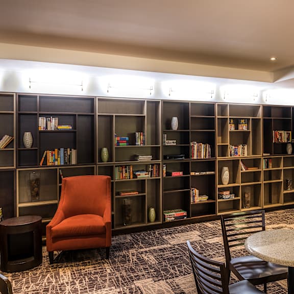 a room with a bar and a bookshelf.