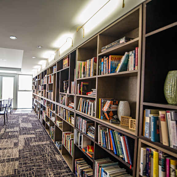 a library with bookshelves and chairs.