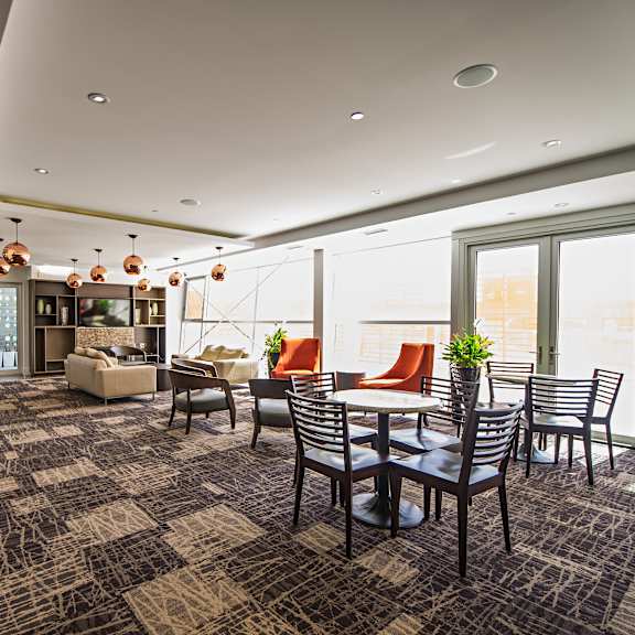 a modern dining room with a large table and chairs.