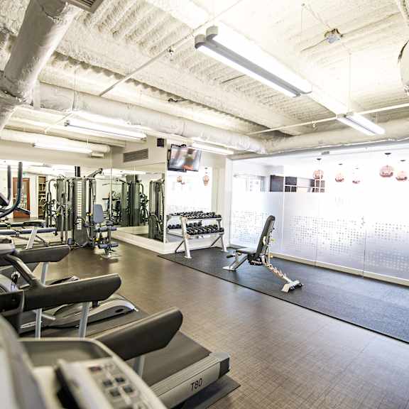 a gym with treadmills and exercise equipment.