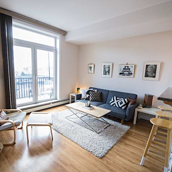 a living room with a couch, chair, and table.