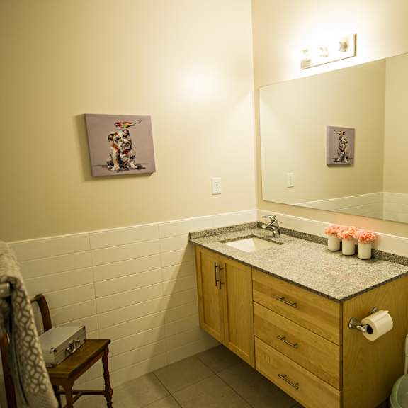 a bathroom with a wooden vanity and a toilet.