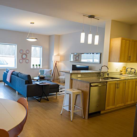 a kitchen with a table and chairs in the middle of the room.