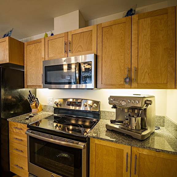a kitchen with wooden cabinets and a black stove top.