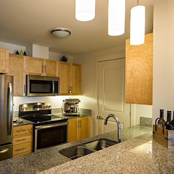 a kitchen with a granite counter top and stainless steel appliances.