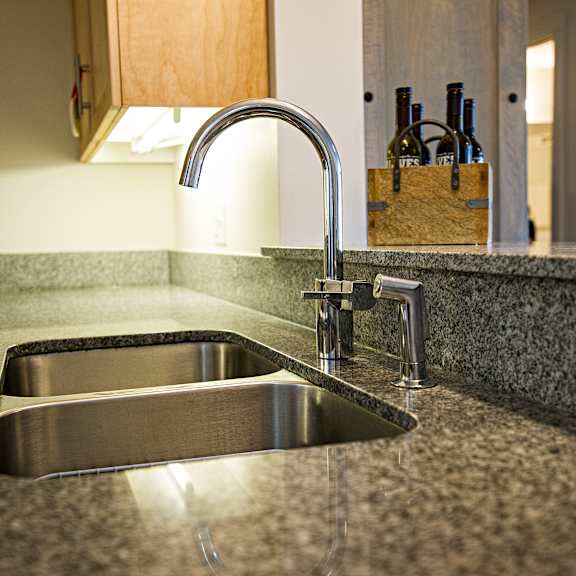 a modern kitchen sink with a chrome faucet.