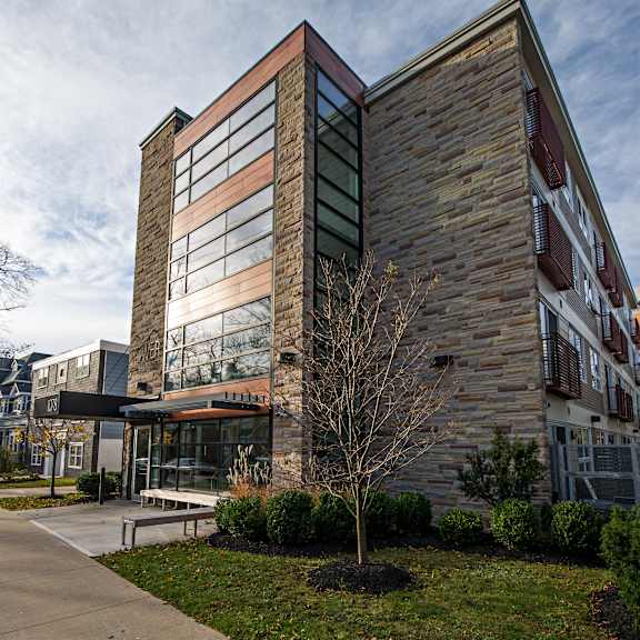 a modern building with a glass facade and a wooden exterior.