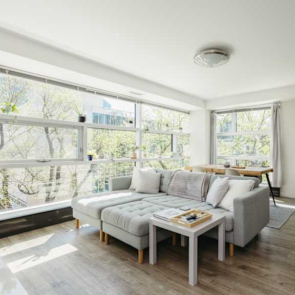 a living room with a grey couch and a wooden coffee table.