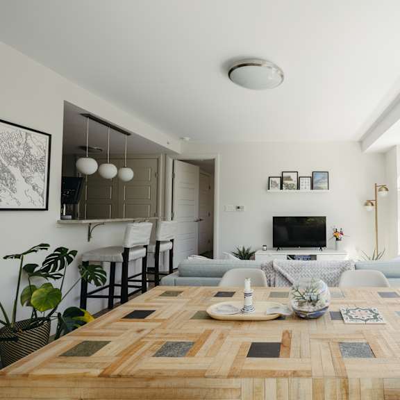 a modern dining room with a wooden table and chairs.