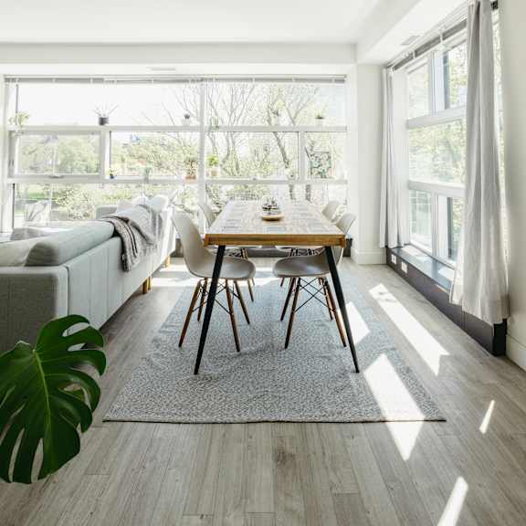 a dining room with a table and chairs in front of a large window.