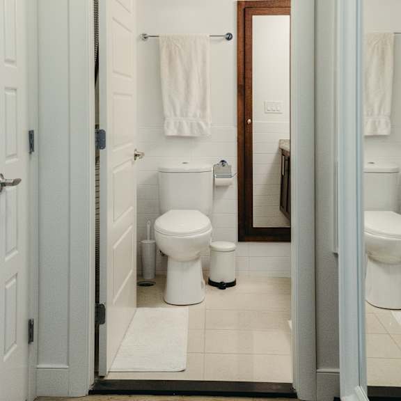 a white toilet sits in a bathroom next to a white sink.