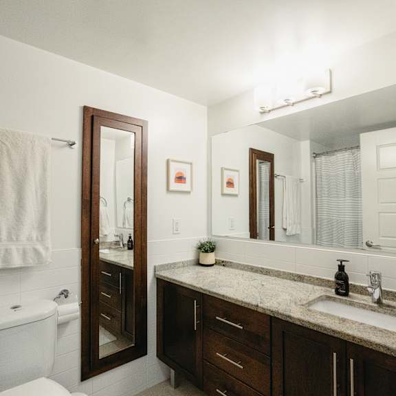 a bathroom with a white toilet and a sink.