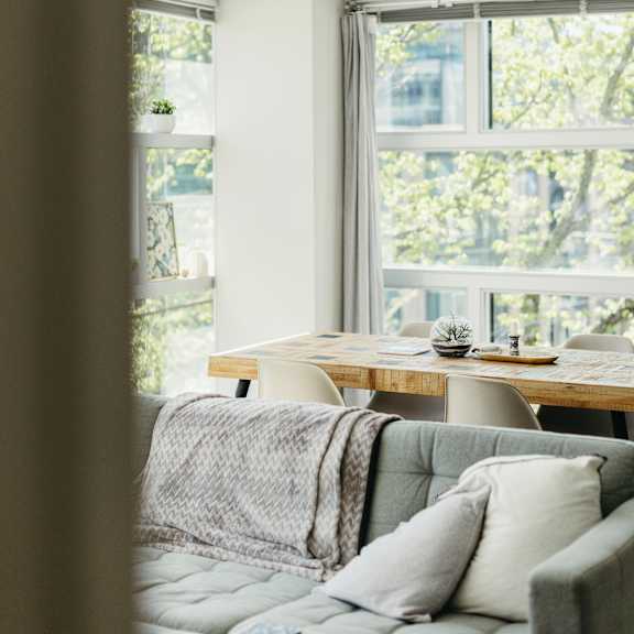 a living room with a grey couch and a wooden table.