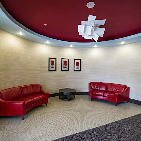 two red couches in a room with a white ceiling.