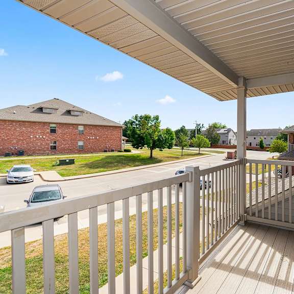 a balcony with a railing and a roof over it.