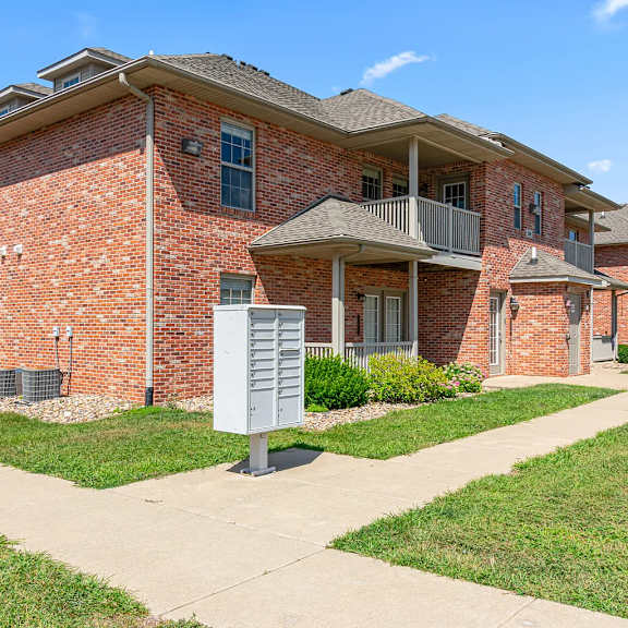 a brick building with a mailbox in front.