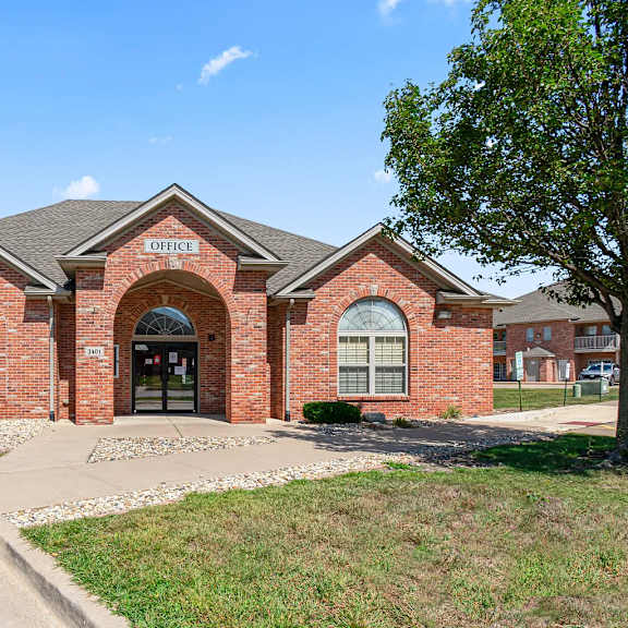 a brick building with the words "office" written above the entrance.
