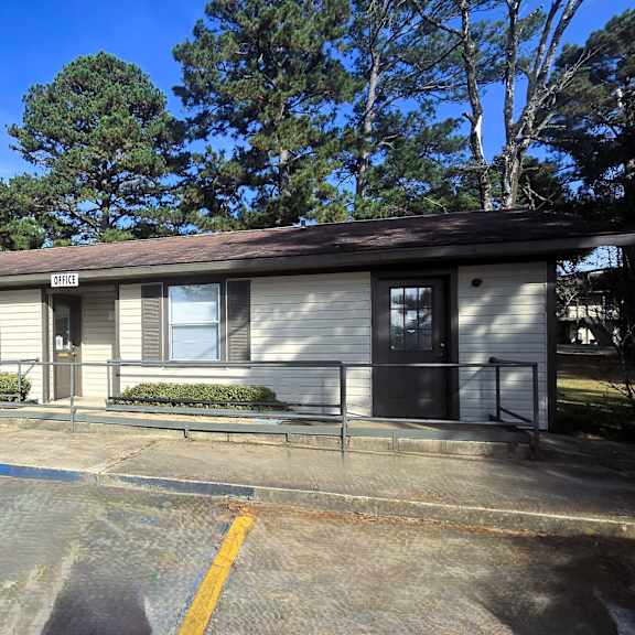 a small building with a brown roof and a sign that says "entrance" on it.