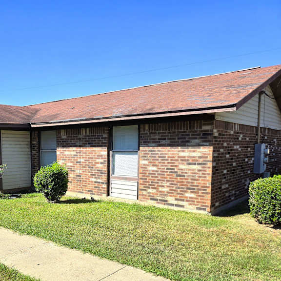 a house with a red roof and a white garage door.
