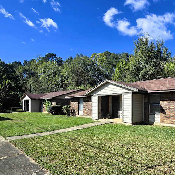 a house with a brown roof and a white garage door.