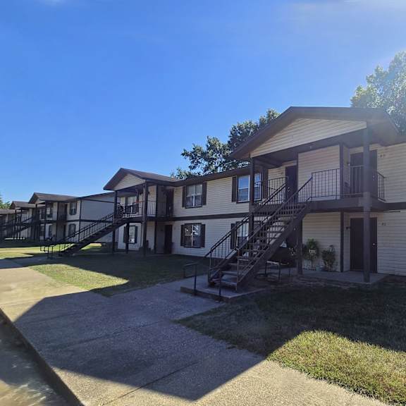 a sunny day at a residential complex with a building in the foreground.