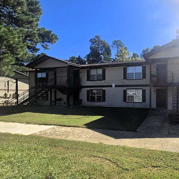 a large house with a balcony and a staircase leading to the second floor.