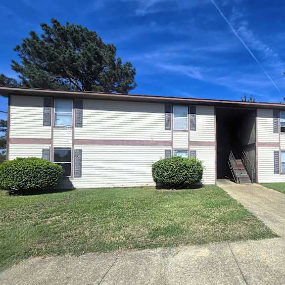 a two-story residential building with a garage door entrance.