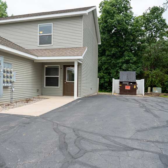 a house with a grey garage door and a grey wall.