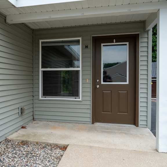 a house with a brown door and a window.