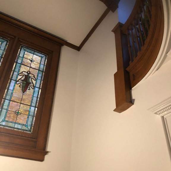 a stained glass window in a white wall.