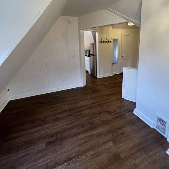 a room with wooden floors and white walls.