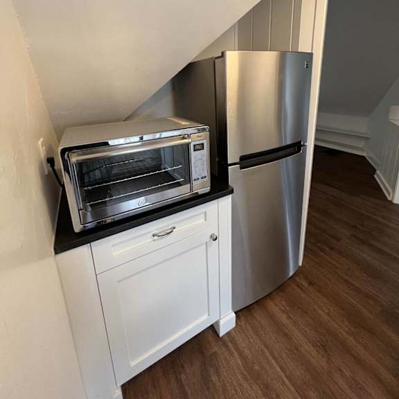 a kitchen with a stainless steel refrigerator and oven.