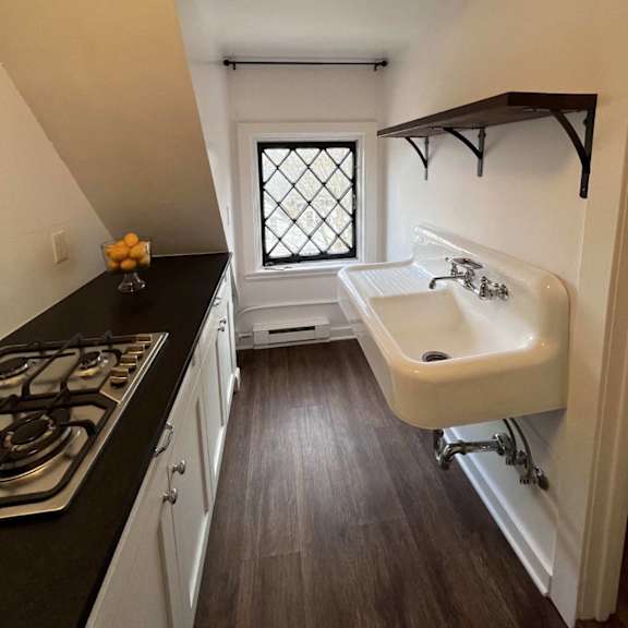 a kitchen with a black countertop and white cabinets.