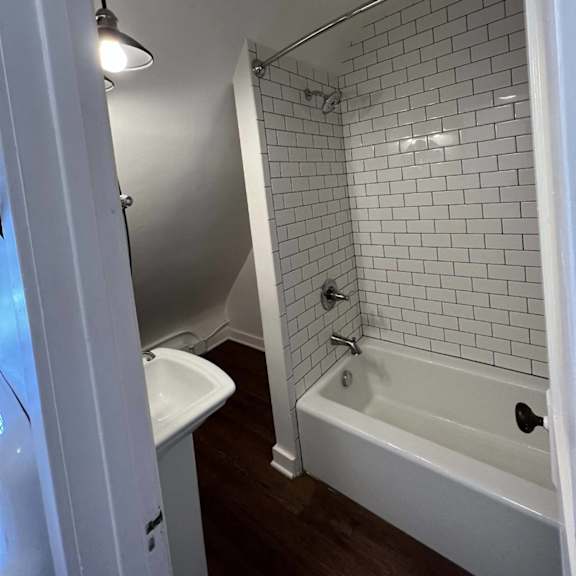 a white bathroom with a white tub and sink.