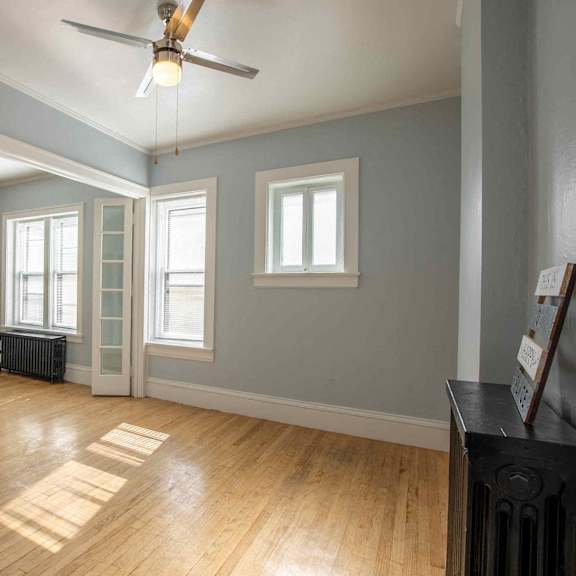 a room with wooden floors and a ceiling fan.