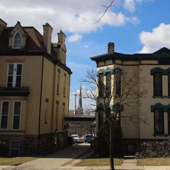 two large houses with dark trim and shutters.