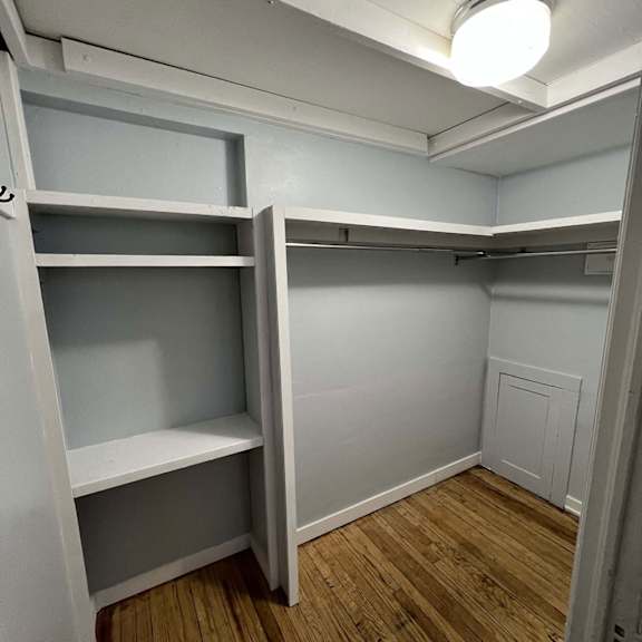 a small, empty room with a shelving unit and a light on the ceiling.