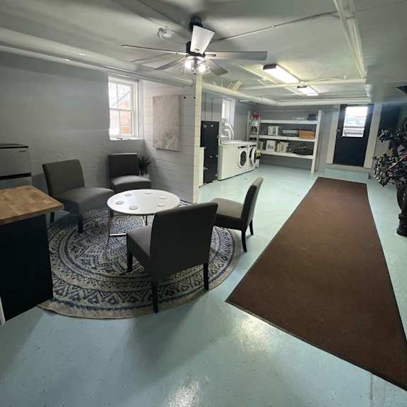 a room with a table and chairs in it.