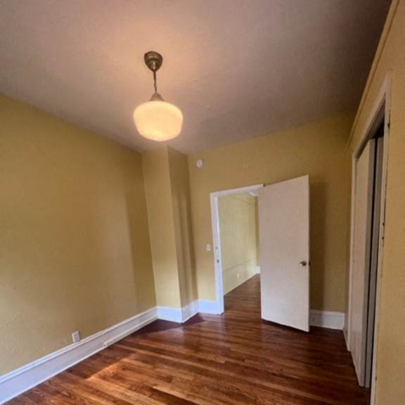a wooden staircase with a light on the wall.