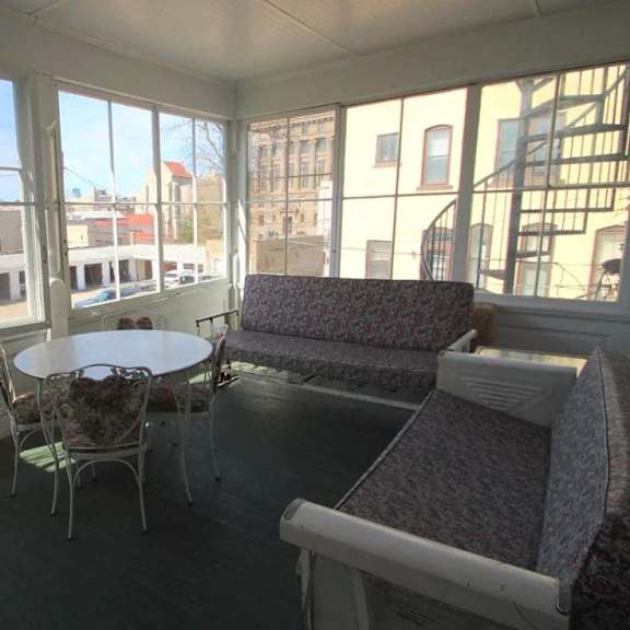 a sunny day in a room with a table and chairs.