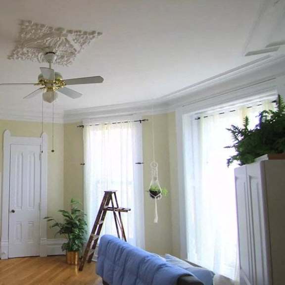 a room with a ceiling fan and a bed.