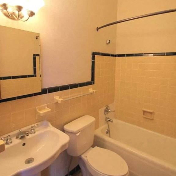 a white toilet sits next to a sink in a bathroom.