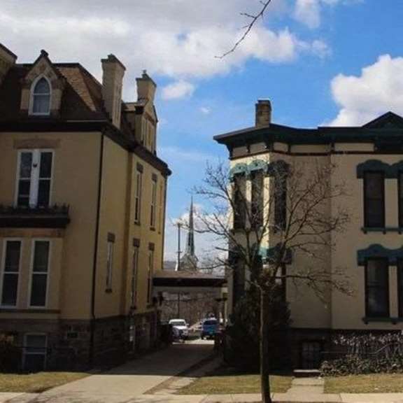 two large houses with dark trim and shutters.