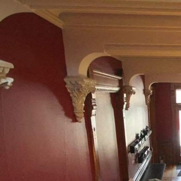 a room with red walls and a balcony.
