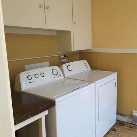 a washing machine and dryer in a small laundry room.