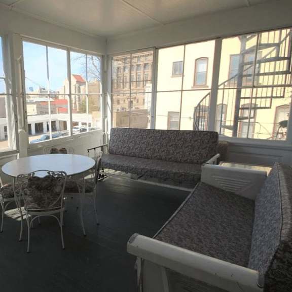 a sunny day in a room with a table and chairs.