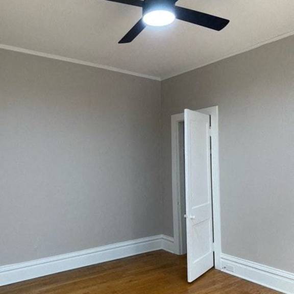 a room with a ceiling fan and a door.